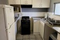 The kitchen of Chesapeake Bay 38. The 5 sleeper self-catering holiday flat has tennis courts, pool, coin operated laundry and jungle gym and is on the beach in Margate on the South Coast of KZN - Happy Holiday Homes