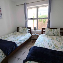 On Margate seafront Chesapeake Bay 22 has tennis courts and a swimming pool - Sleeps 4 guests - South Coast KwaZulu-Natal self-catering Accommodation - Happy Holiday Homes