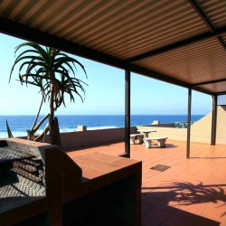 C - Front 11 is a self-catering holiday penthouse on Manaba sea front with an 180 degree sea view that sleeps 7 and is walking distance to Lucien Blue Flag Beach.