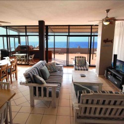 C - Front 11 is a self-catering holiday penthouse on Manaba sea front with an 180 degree sea view that sleeps 7 and is walking distance to Lucien Blue Flag Beach.