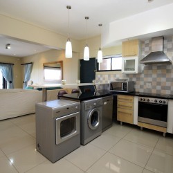 Whale Rock 16 is a 3 bedroom, 6 sleeper self-catering holiday flat in Margate on the South Coast of KZN - The kitchen.