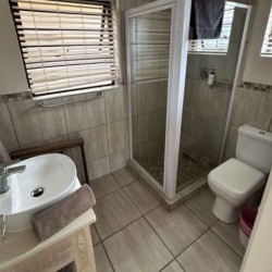 Banana Beach Club F1, a self-catering ground-floor studio in Melville on the Hibiscus Coast, located 50m from the beach, ideal for a small family holiday.