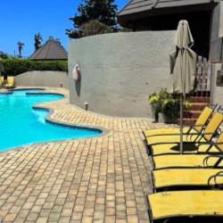 Banana Beach Club F1, a self-catering ground-floor studio in Melville on the Hibiscus Coast, located 50m from the beach, ideal for a small family holiday.