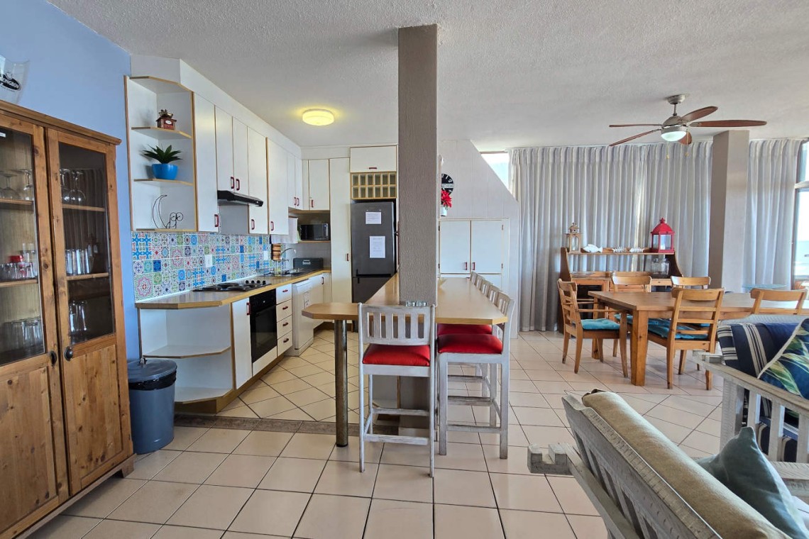 The open plan kitchen and breakfast counter at C - Front 11 a self-catering holiday penthouse on Manaba sea front with an 180 degree sea view.