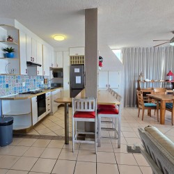 The open plan kitchen and breakfast counter at C - Front 11 a self-catering holiday penthouse on Manaba sea front with an 180 degree sea view.