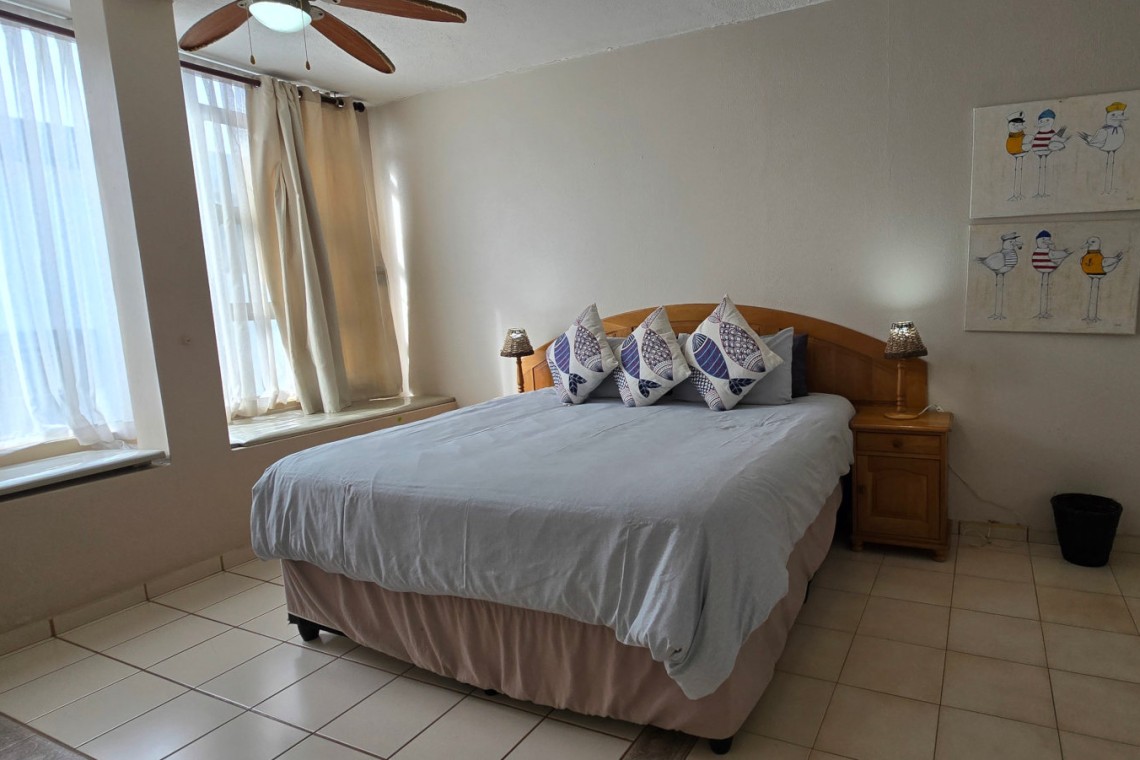 Main bedroom with ensuite bathroom at C Front 11 penthouse, 7-sleeper holiday accommodation