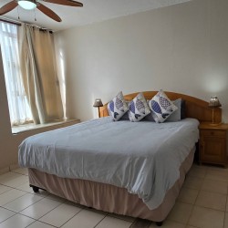 Main bedroom with ensuite bathroom at C Front 11 penthouse, 7-sleeper holiday accommodation