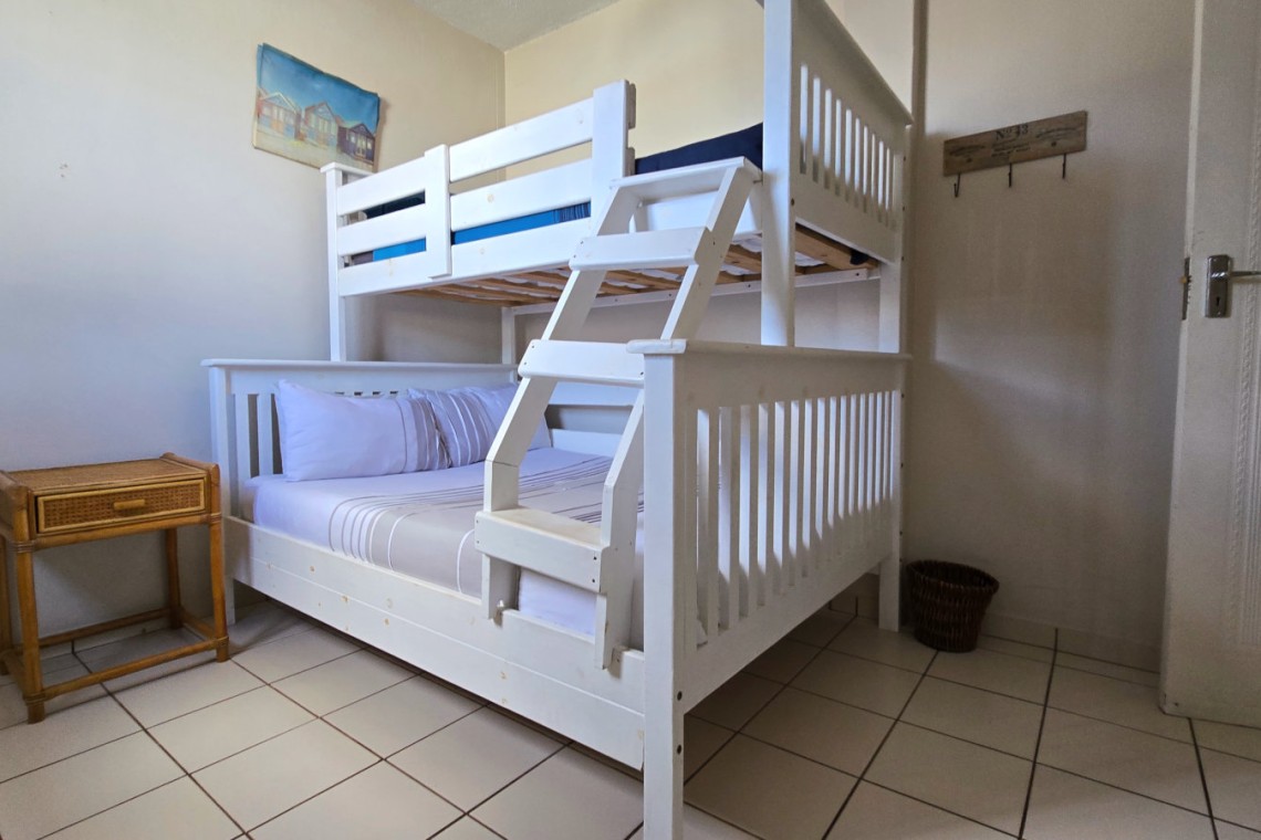 The third bedroom at C - Front 11, a self-catering holiday penthouse on Manaba sea front with an 180 degree sea view that sleeps 7 and is walking distance to Lucien Blue Flag Beach.