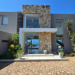 Strachan 2127 is a luxury holiday home in Ramsgate, located on the beachfront of Ramsgate Beach. This stunning sea-view rental in KwaZulu-Natal offers breathtaking ocean views, an infinity pool, and modern comforts—making it the perfect family-friendly getaway in South Africa.