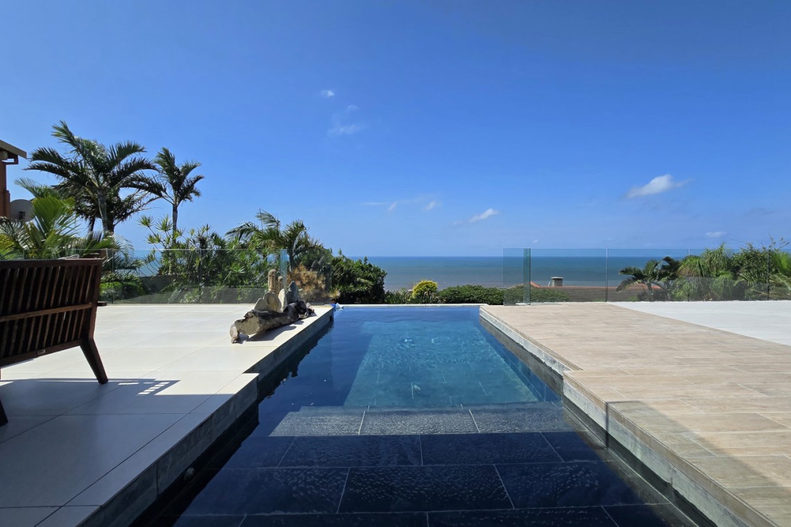 Strachan 2127 is a luxury holiday home in Ramsgate, located on the beachfront of Ramsgate Beach. This stunning sea-view rental in KwaZulu-Natal offers breathtaking ocean views, an infinity pool, and modern comforts—making it the perfect family-friendly getaway in South Africa.
