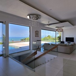 Strachan 2127 is a luxury holiday home in Ramsgate, located on the beachfront of Ramsgate Beach. This stunning sea-view rental in KwaZulu-Natal offers breathtaking ocean views, an infinity pool, and modern comforts—making it the perfect family-friendly getaway in South Africa.
