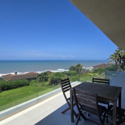 Strachan 2127 is a luxury holiday home in Ramsgate, located on the beachfront of Ramsgate Beach. This stunning sea-view rental in KwaZulu-Natal offers breathtaking ocean views, an infinity pool, and modern comforts—making it the perfect family-friendly getaway in South Africa.
