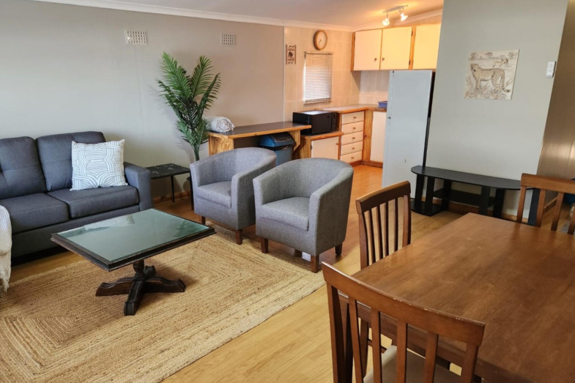 Sea Park House, the right wing lounge with door to patio, garden and swimming pool in holiday home with sea view in Sea Park on the South Coast of KwaZulu Natal