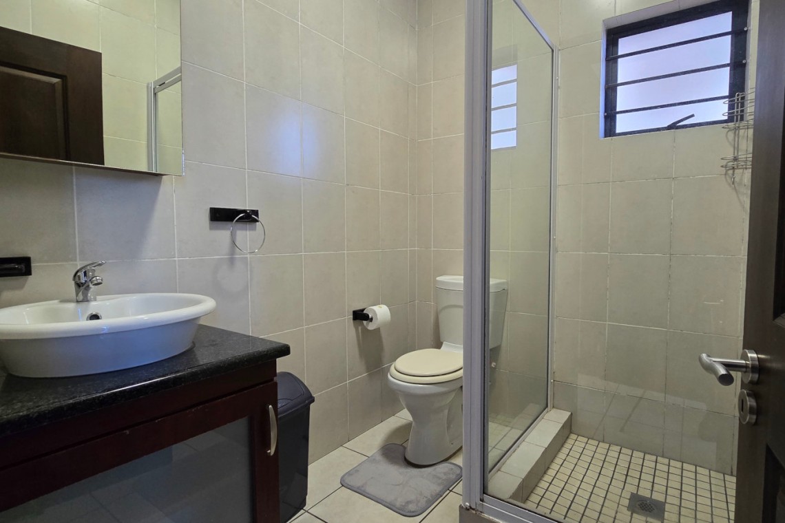 Modern en-suite bathroom at Topanga 25, part of a sea facing 6 sleeper in Uvongo offering affordable holiday accommodation in Uvongo near the beach.