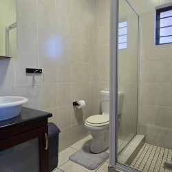 Modern en-suite bathroom at Topanga 25, part of a sea facing 6 sleeper in Uvongo offering affordable holiday accommodation in Uvongo near the beach.