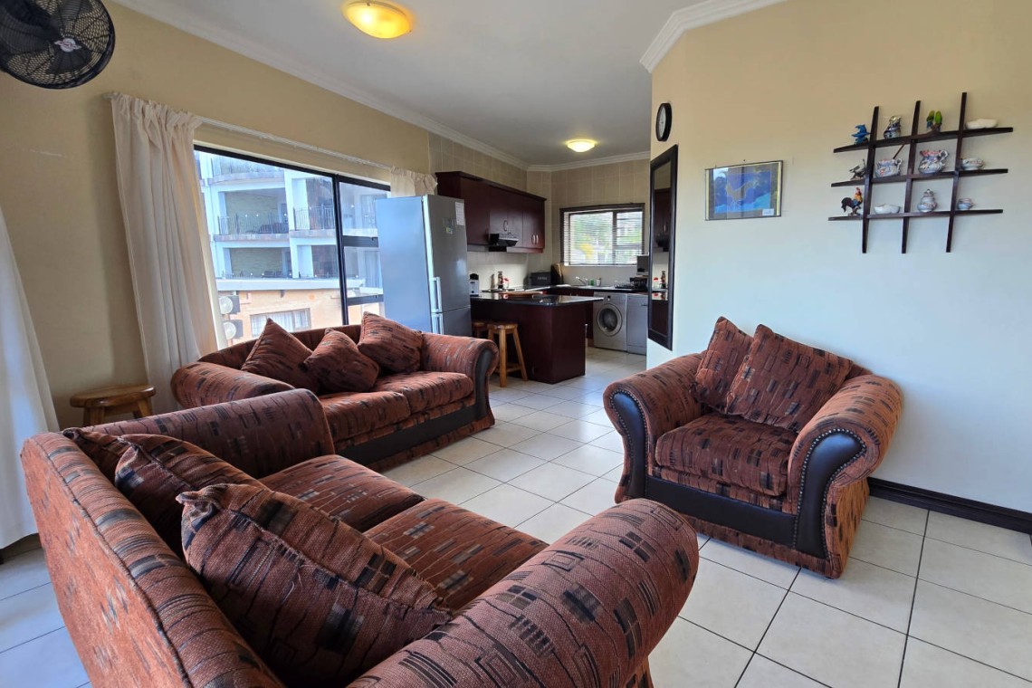 Open-plan living area at Topanga 25, an affordable holiday accommodation in Uvongo designed for relaxed family beach holidays close to the sea.