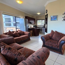Open-plan living area at Topanga 25, an affordable holiday accommodation in Uvongo designed for relaxed family beach holidays close to the sea.