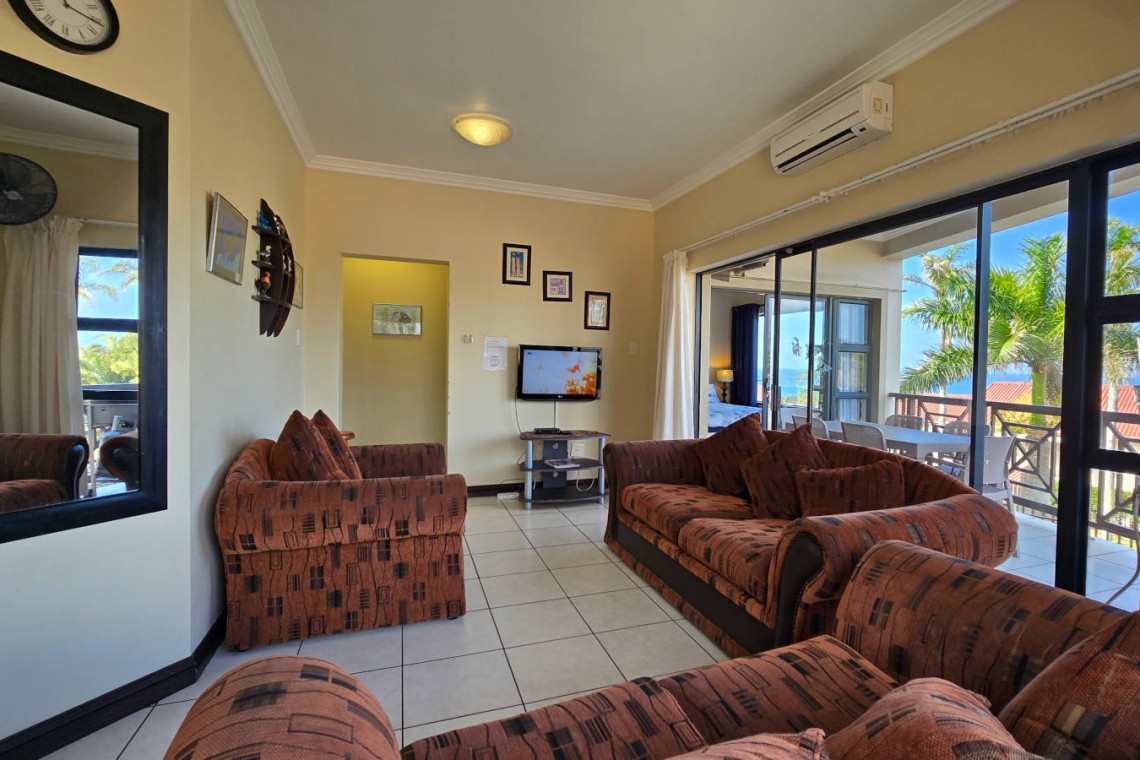 Lounge at Topanga 25 – comfortable and coastal, in a sea facing 6 sleeper in Uvongo just a short walk to Uvongo beach and shops.
