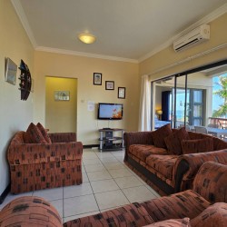 Lounge at Topanga 25 – comfortable and coastal, in a sea facing 6 sleeper in Uvongo just a short walk to Uvongo beach and shops.