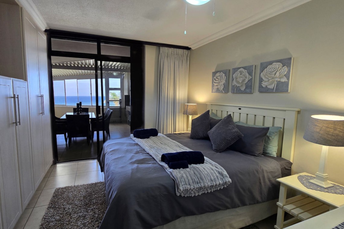Queen bed main bedroom of Chardonnay Cabanas 5 with ensuite and sliding doors to patio