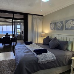 Queen bed main bedroom of Chardonnay Cabanas 5 with ensuite and sliding doors to patio