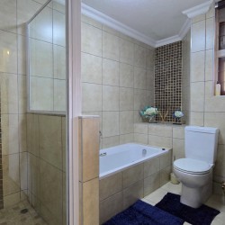 Main ensuite bathroom at Chardonnay Cabanas 5 with bath and separate shower