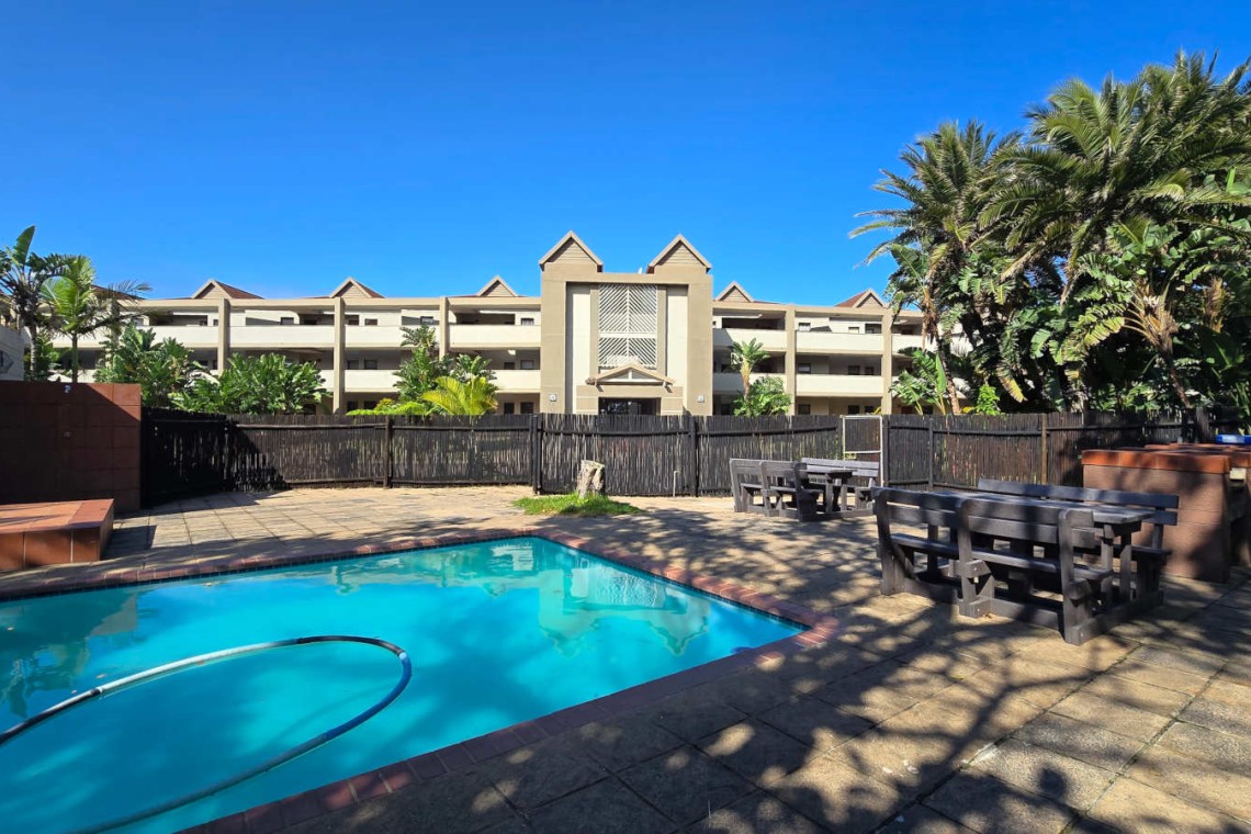 The swimming pool at Portofino complex with shade, and on-site braais —ideal for sunny family days.