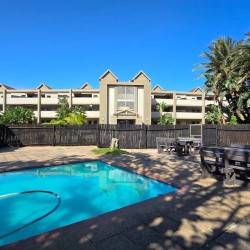 The swimming pool at Portofino complex with shade, and on-site braais —ideal for sunny family days.