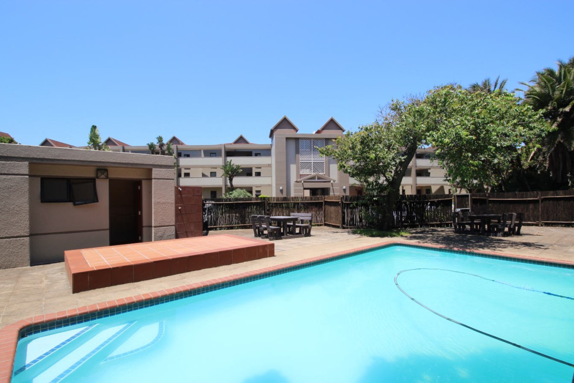 Secure swimming pool and braai area at Portofino 15 in Shelly Beach