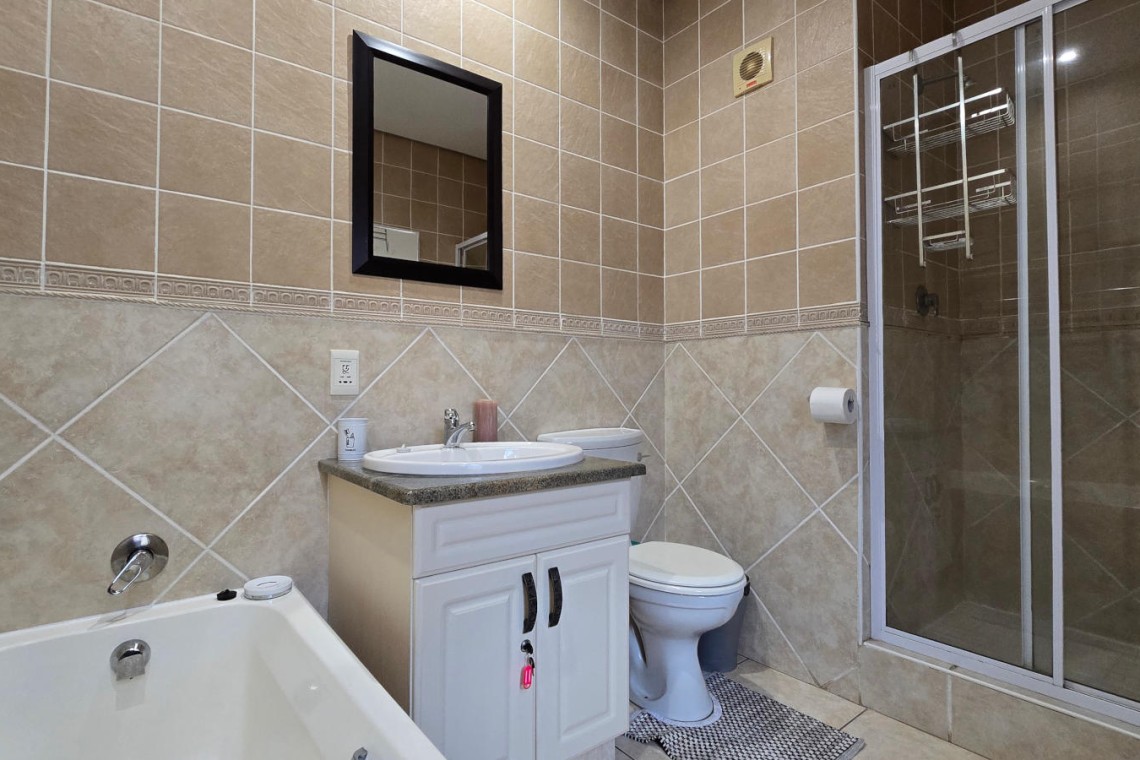 The fully fitted en-suite bathroom off the main bedroom at Portofino 15.