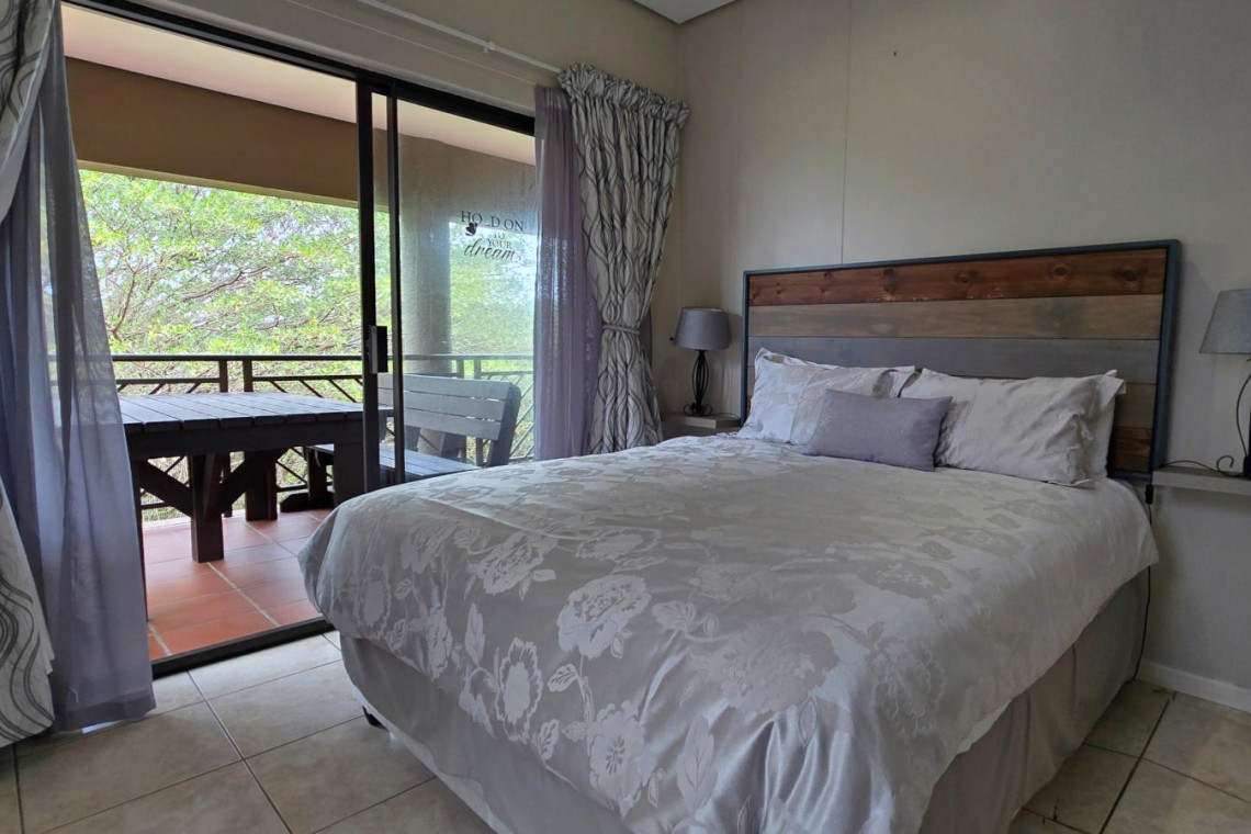 Second bedroom with a queen-sized bed at Portofino 15 in Shelly Beach