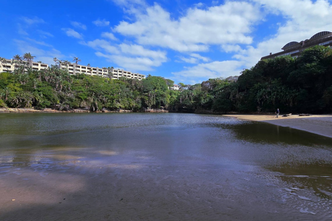 Calm lagoon with sandy beach near Chardonnay Cabanas 5 on Uvongo Beach