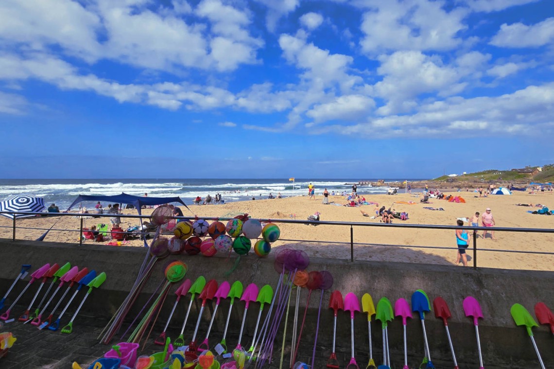 Holiday makers sunning on Uvongo Beach just steps from Chardonnay Cabanas 5