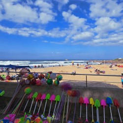Holiday makers sunning on Uvongo Beach just steps from Chardonnay Cabanas 5